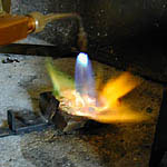Melting the metal with a torch